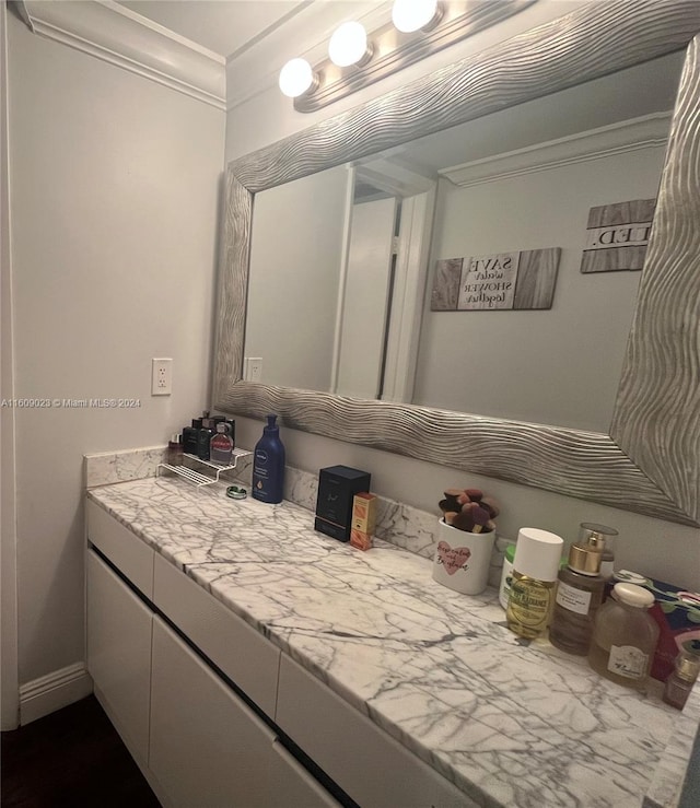 bathroom with vanity and crown molding