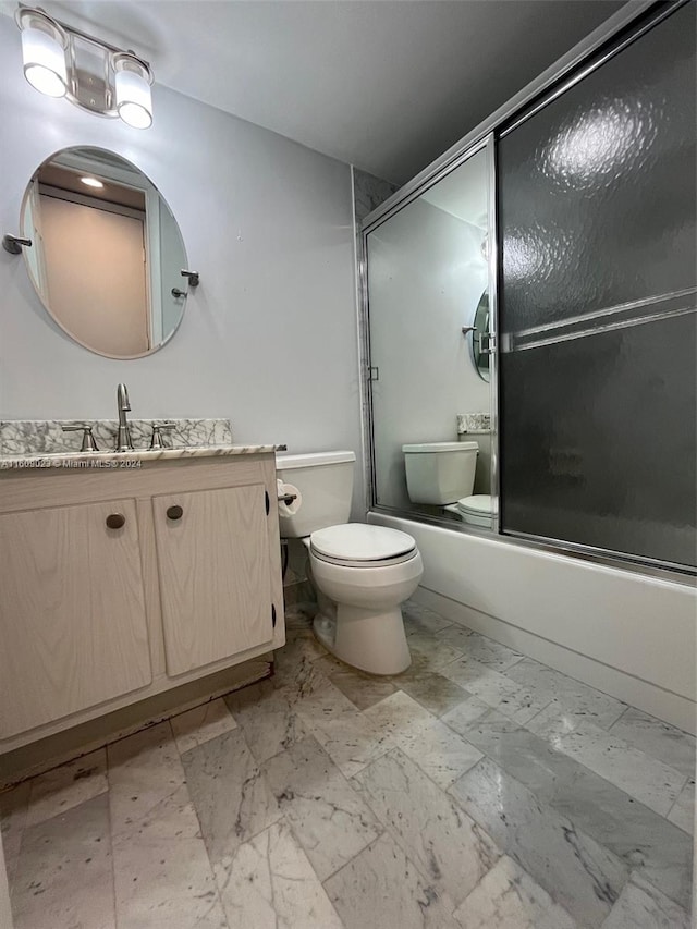 full bathroom featuring shower / bath combination with glass door, vanity, and toilet