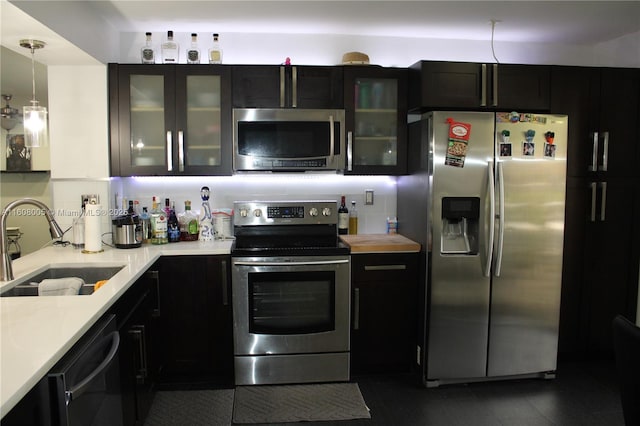 kitchen featuring sink, pendant lighting, and appliances with stainless steel finishes