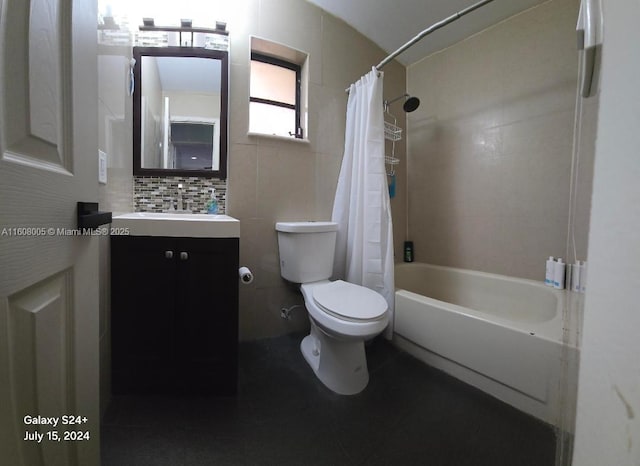 full bathroom featuring vanity, toilet, tile walls, tasteful backsplash, and shower / tub combo