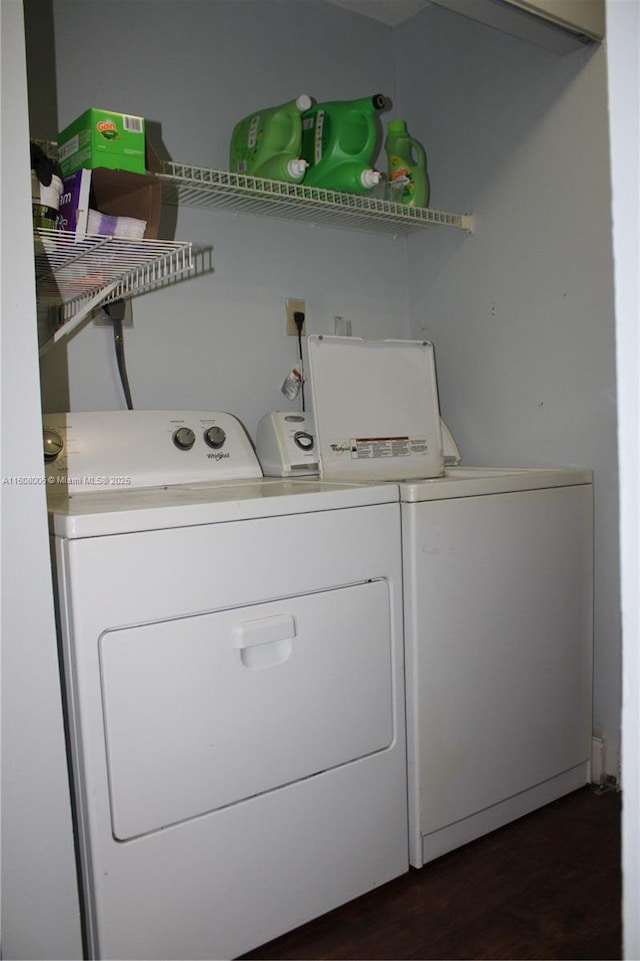 laundry room featuring washer and dryer and dark wood-type flooring