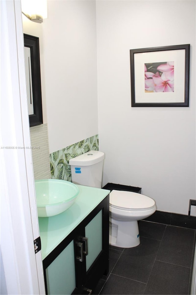 bathroom featuring tile patterned floors, vanity, and toilet