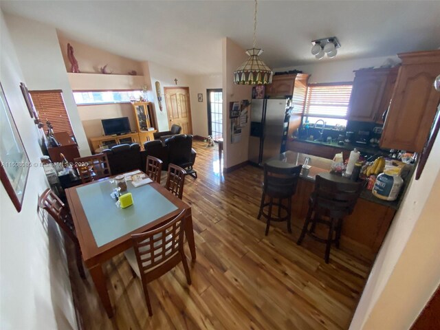 dining space with dark wood-type flooring and lofted ceiling