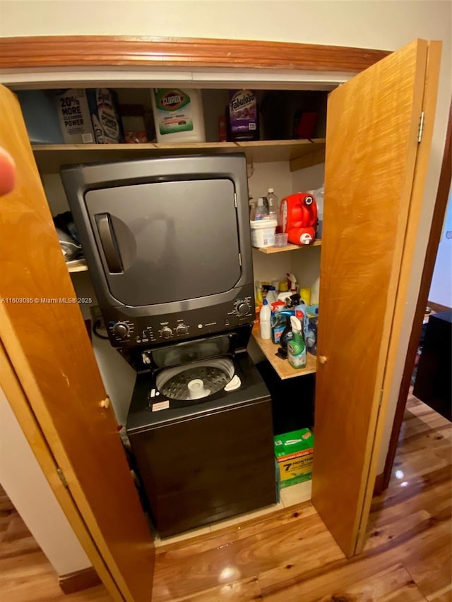 utility room featuring stacked washing maching and dryer