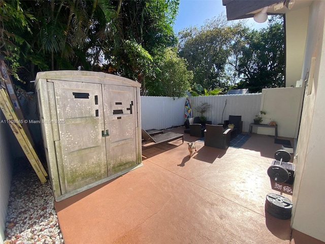 view of patio / terrace featuring an outdoor hangout area and a storage unit