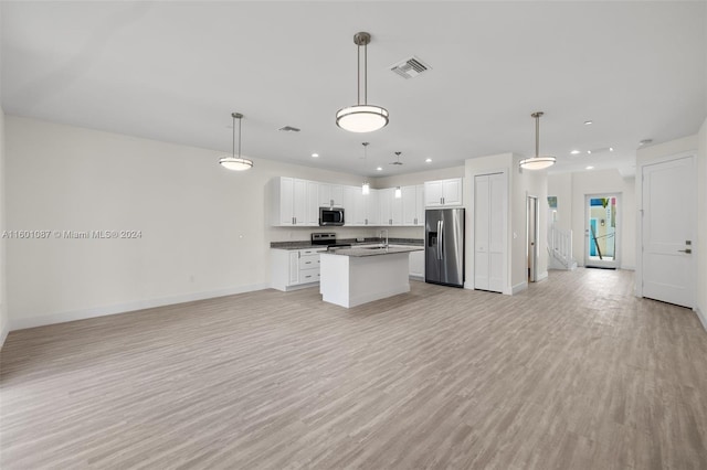 kitchen with pendant lighting, light hardwood / wood-style floors, white cabinetry, and appliances with stainless steel finishes