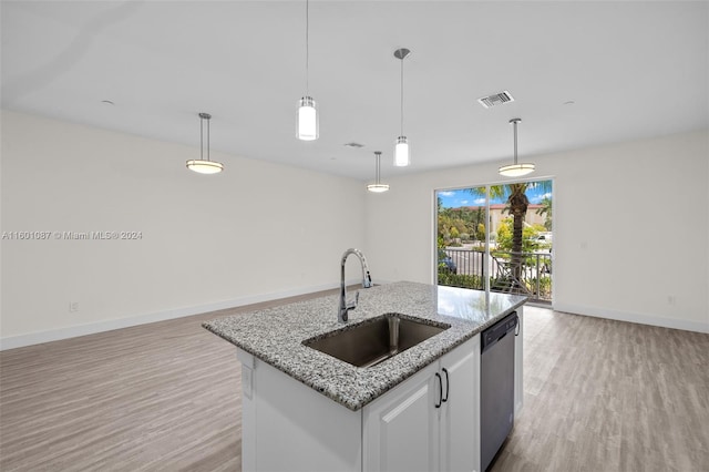 kitchen with decorative light fixtures, dishwasher, a center island with sink, sink, and white cabinetry