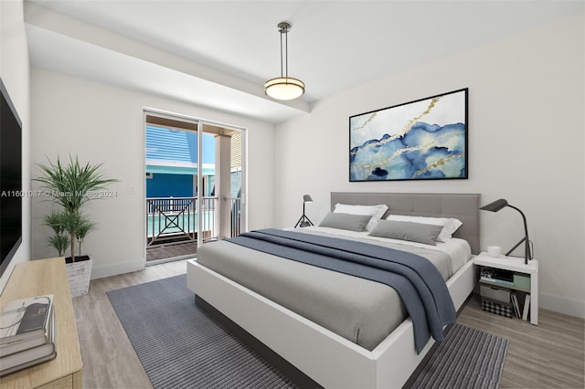 bedroom featuring access to exterior and wood-type flooring