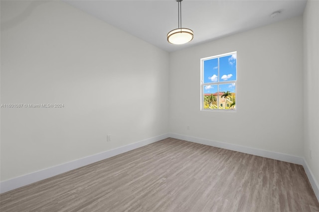 unfurnished room with light wood-type flooring