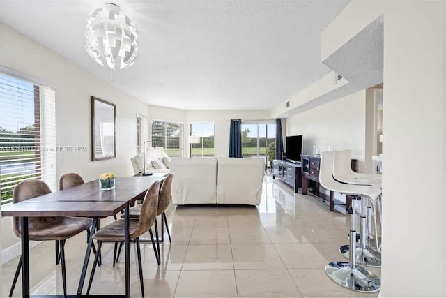 tiled dining area with a notable chandelier