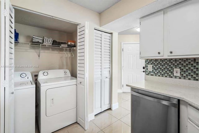 washroom featuring separate washer and dryer and light tile patterned flooring