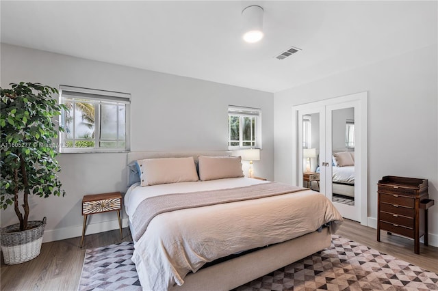 bedroom with french doors and hardwood / wood-style floors