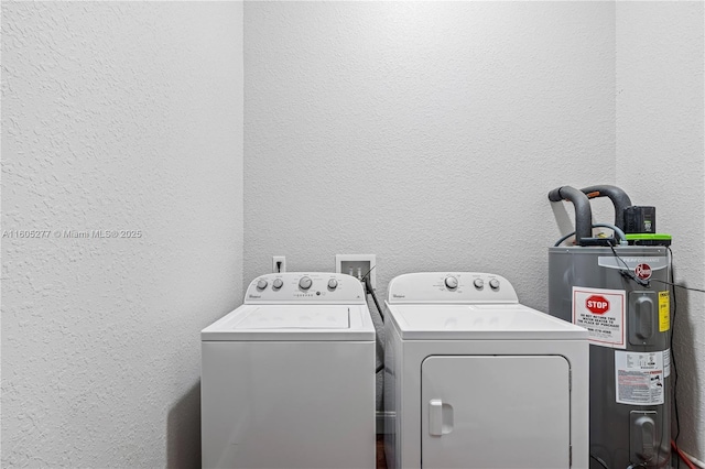 clothes washing area featuring independent washer and dryer and electric water heater