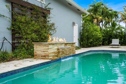 view of swimming pool with exterior bar