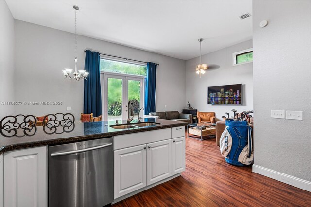 kitchen featuring kitchen peninsula, stainless steel appliances, a high ceiling, dark hardwood / wood-style floors, and white cabinets