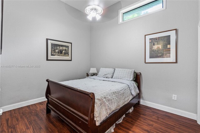 bedroom with dark wood-type flooring and ceiling fan