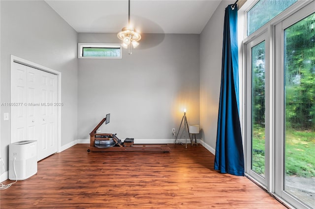 unfurnished room featuring ceiling fan, a healthy amount of sunlight, and hardwood / wood-style floors