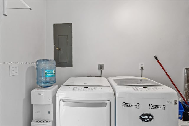 washroom with electric panel and washer and dryer