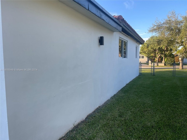 view of side of property with a yard