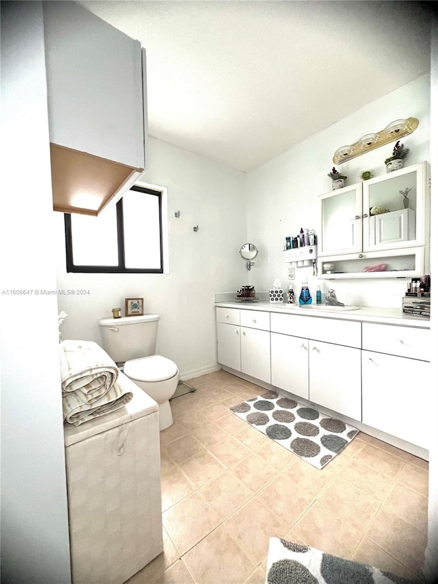 bathroom featuring tile patterned floors, toilet, and vanity