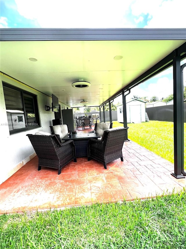 view of patio / terrace featuring an outdoor living space and a storage shed