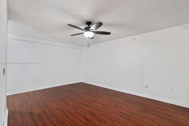 empty room with ceiling fan, a textured ceiling, and dark hardwood / wood-style flooring