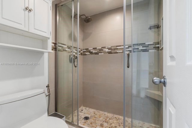 bathroom featuring walk in shower and toilet