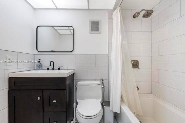 full bathroom featuring tile walls, shower / tub combo with curtain, vanity, and toilet