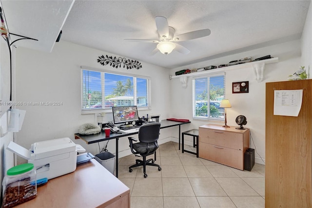 tiled office space with ceiling fan and a textured ceiling