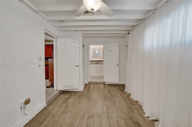 hallway with beamed ceiling and light wood-type flooring