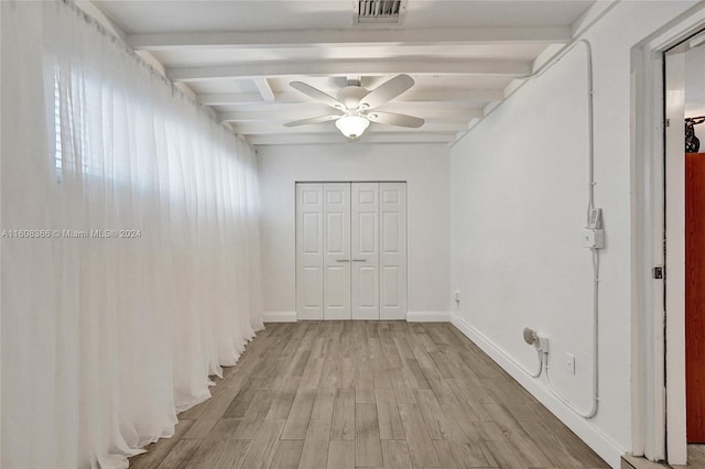 interior space with ceiling fan, beamed ceiling, and light wood-type flooring