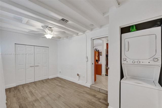 laundry room with ceiling fan, stacked washer / drying machine, and light hardwood / wood-style flooring