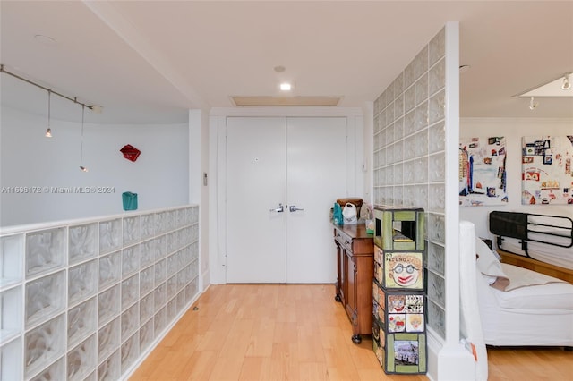 interior space with light hardwood / wood-style flooring and crown molding