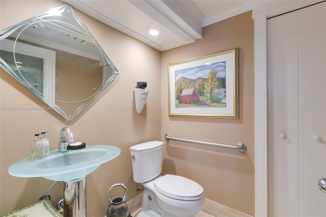 bathroom with crown molding and toilet