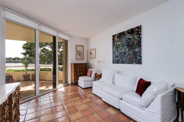 tiled living room featuring a healthy amount of sunlight and floor to ceiling windows