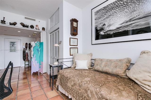 bedroom featuring tile patterned flooring and a closet