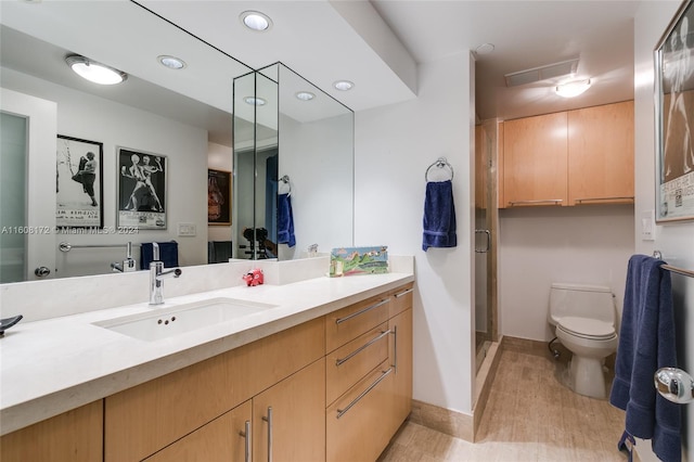 bathroom with walk in shower, vanity, toilet, and hardwood / wood-style flooring