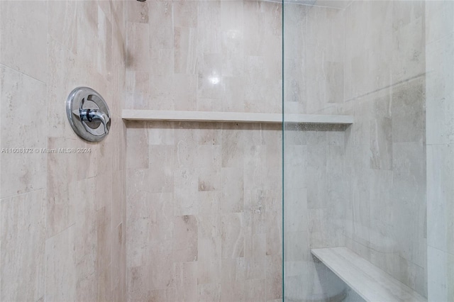 interior details featuring tiled shower