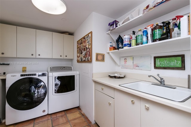 laundry area with cabinets, independent washer and dryer, and sink