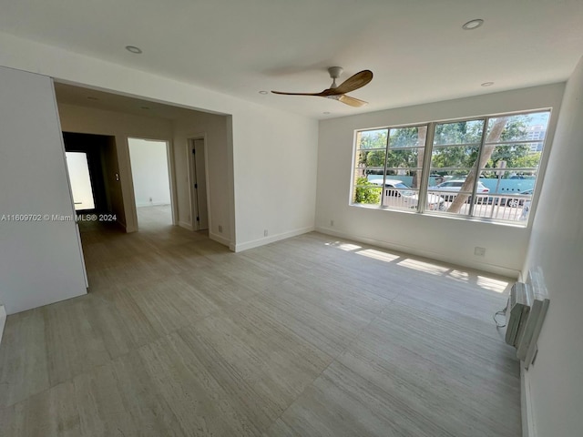 unfurnished room featuring a wealth of natural light and ceiling fan