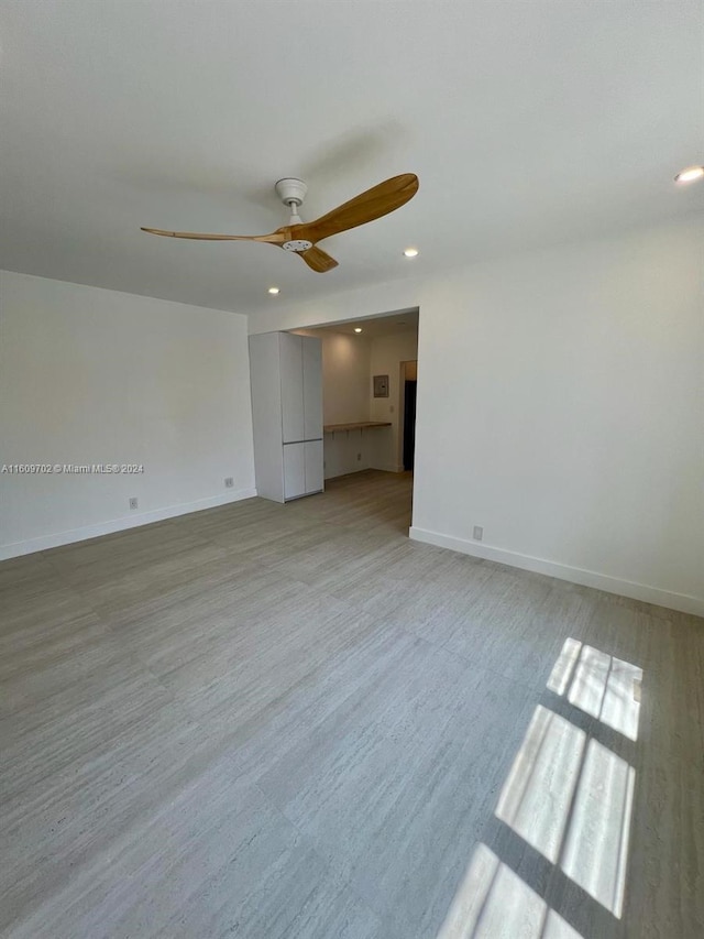 unfurnished bedroom featuring light wood-type flooring and ceiling fan