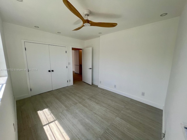 unfurnished bedroom featuring a closet and ceiling fan