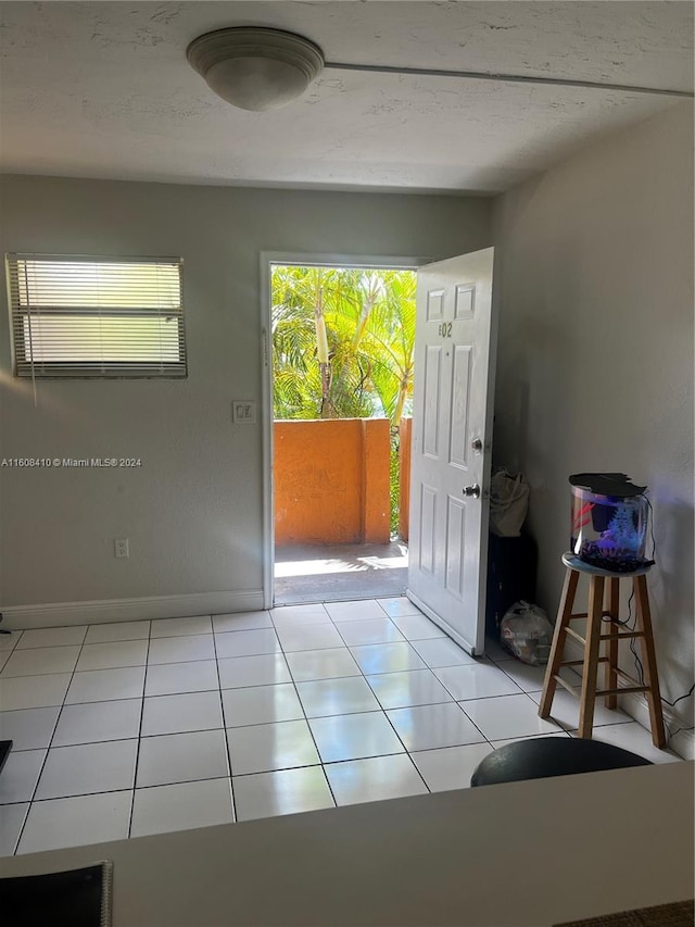 entryway featuring light tile flooring