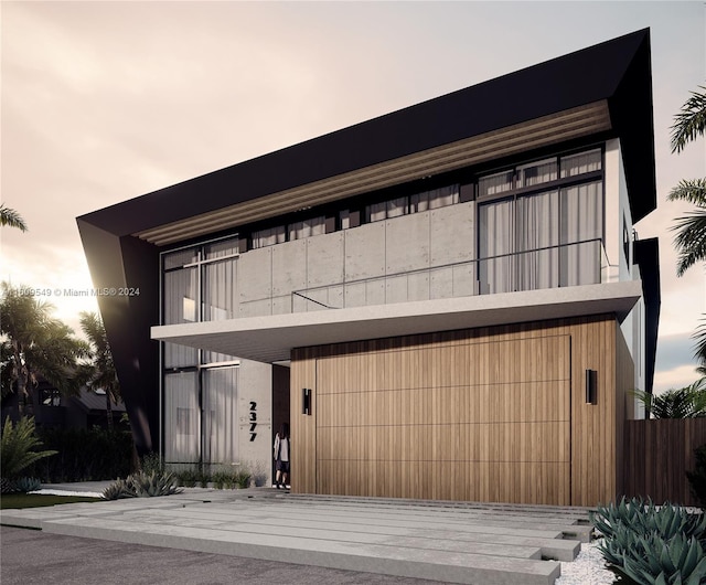 modern home featuring a garage and a balcony