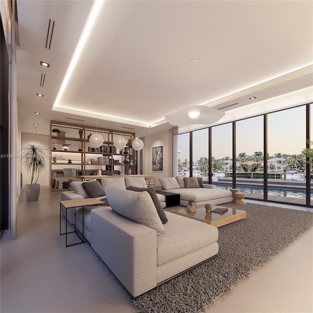 living room featuring a raised ceiling and floor to ceiling windows