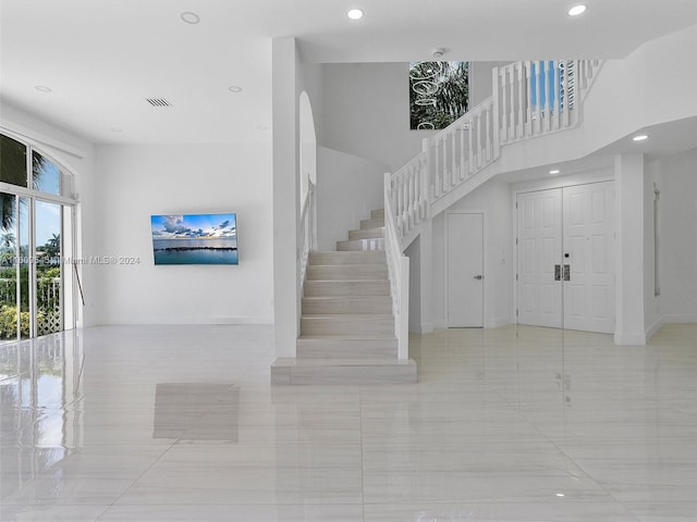 stairs featuring light tile flooring