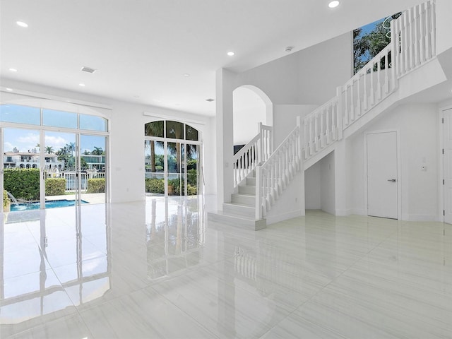 unfurnished living room featuring light tile floors