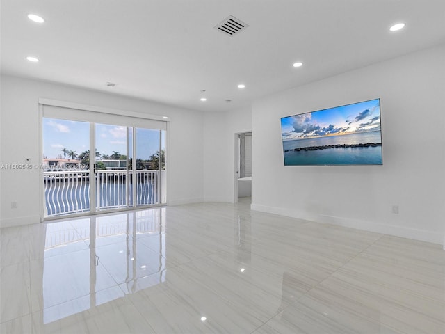 spare room with light tile floors