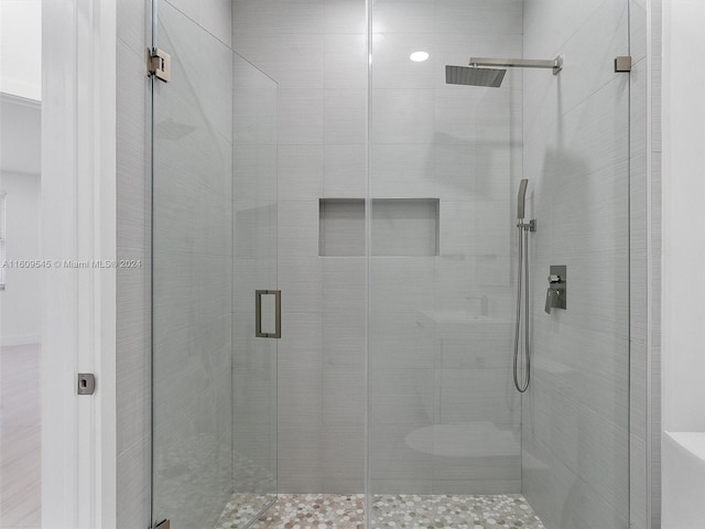 bathroom with walk in shower and toilet