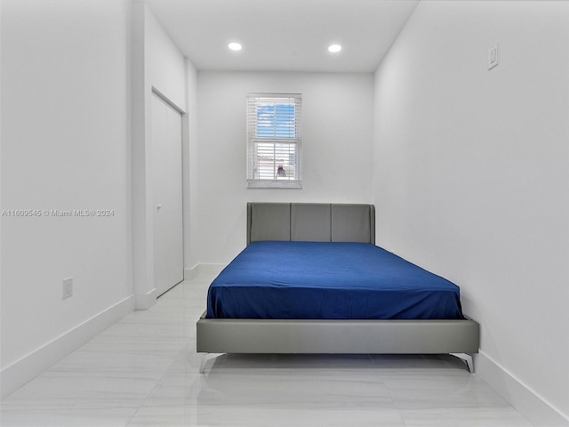 bedroom with light tile floors